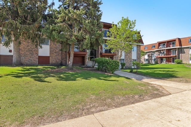 615 Hill Dr Unit 303, Hoffman Estates, IL 60169 - view of front of property with brick siding and a front yard