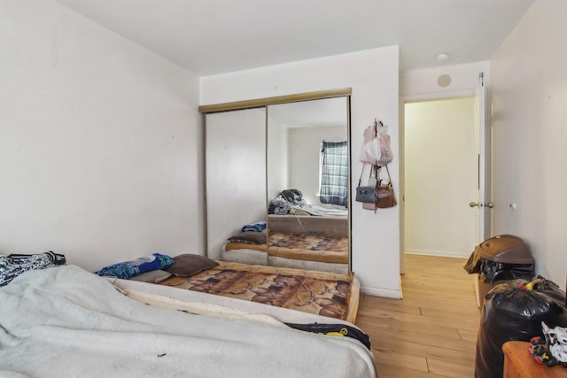 615 Hill Dr Unit 303, Hoffman Estates, IL 60169 - bedroom featuring light wood-type flooring, a closet, and baseboards