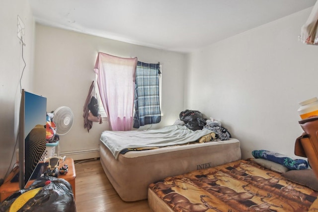 615 Hill Dr Unit 303, Hoffman Estates, IL 60169 - bedroom featuring wood-type flooring and a baseboard radiator