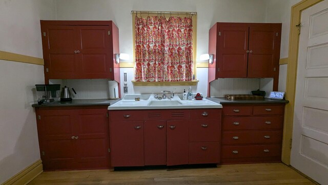 kitchen featuring a sink and light wood-style floors