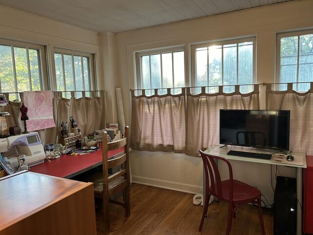 office space with baseboards and wood finished floors