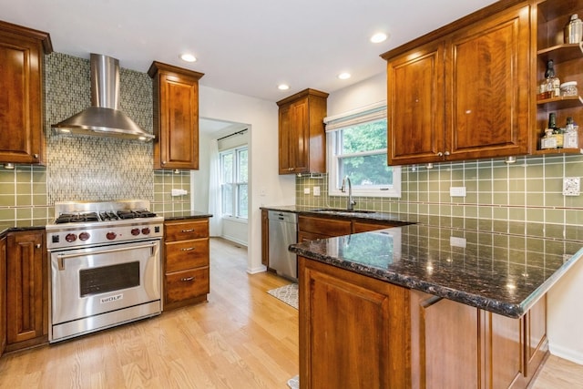 1161 Ardmore Dr, Naperville, IL 60540 - kitchen featuring appliances with stainless steel finishes, wall chimney exhaust hood, a sink, light wood-style flooring, and dark stone counters