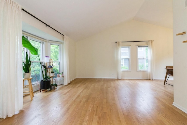 1161 Ardmore Dr, Naperville, IL 60540 - unfurnished living room featuring light wood-style flooring, vaulted ceiling, and baseboards