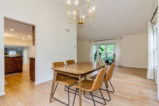 1161 Ardmore Dr, Naperville, IL 60540 - dining area featuring a chandelier, light wood-type flooring, high vaulted ceiling, and baseboards