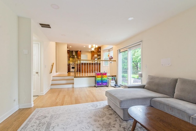 1161 Ardmore Dr, Naperville, IL 60540 - living area with light wood finished floors, stairway, baseboards, recessed lighting, and a chandelier