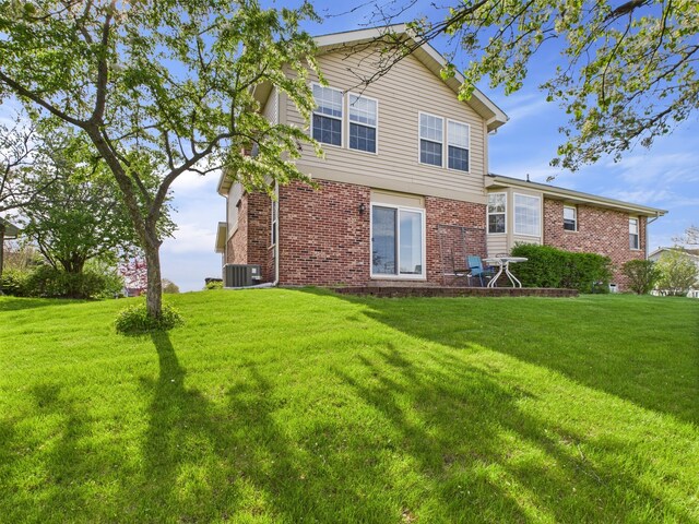 20359 Countryside Ln, Frankfort, IL 60423 - back of property with a yard, brick siding, and central AC unit