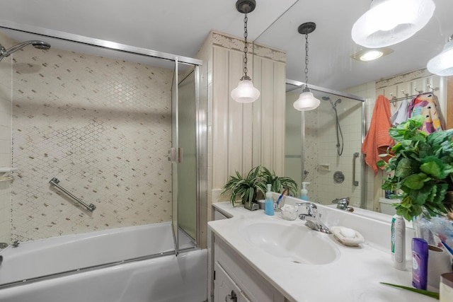 bathroom featuring shower / bath combination with glass door and vanity