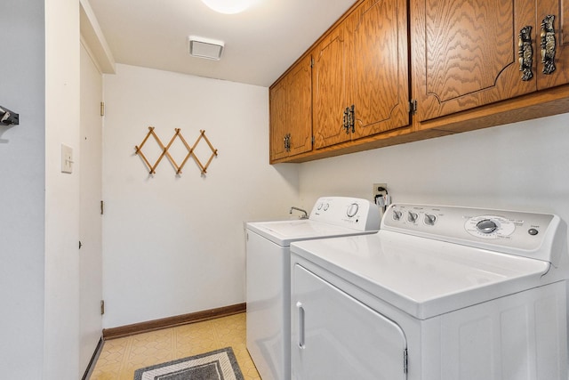 clothes washing area featuring light tile patterned floors, baseboards, cabinet space, and washer and dryer