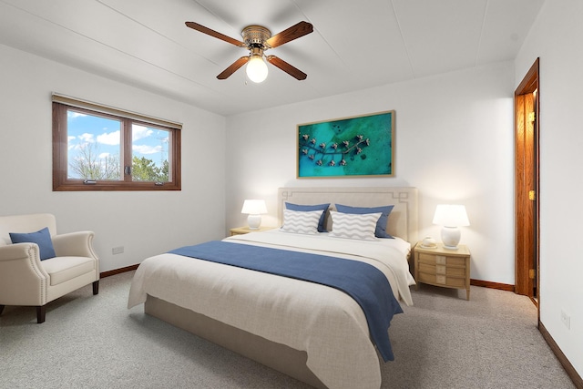 carpeted bedroom with baseboards and a ceiling fan