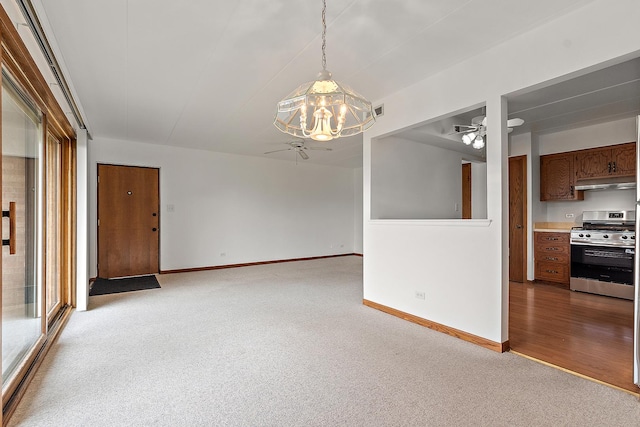 empty room with baseboards, visible vents, light carpet, and ceiling fan with notable chandelier