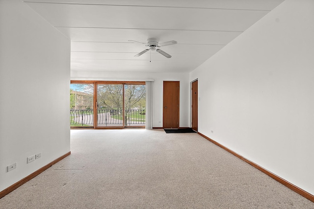 carpeted empty room with baseboards and ceiling fan