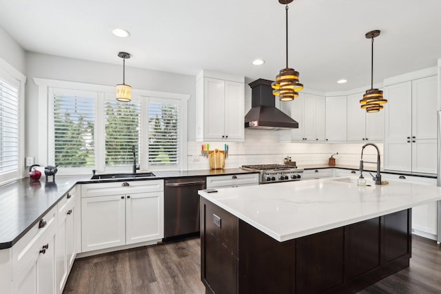 kitchen featuring a sink, wall chimney exhaust hood, stainless steel dishwasher, dark wood-type flooring, and recessed lighting