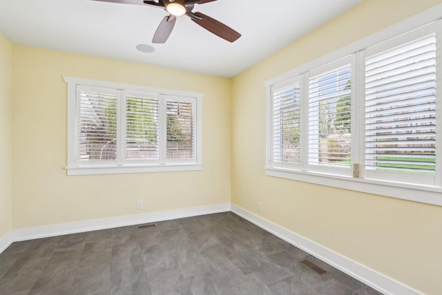 unfurnished room with plenty of natural light, ceiling fan, and baseboards