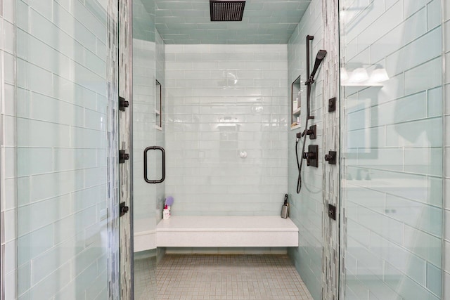 full bathroom with a stall shower and tile patterned flooring