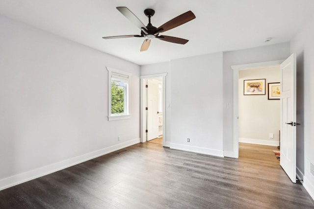 unfurnished bedroom featuring wood finished floors, baseboards, and ceiling fan