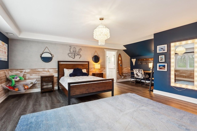 bedroom with a chandelier, wood finished floors, and baseboards