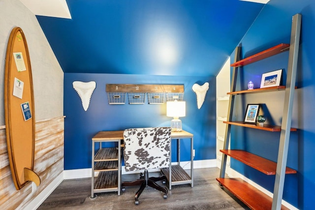 office area with wood finished floors, vaulted ceiling, and baseboards