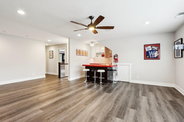 indoor dry bar with wood finished floors, a ceiling fan, recessed lighting, and baseboards