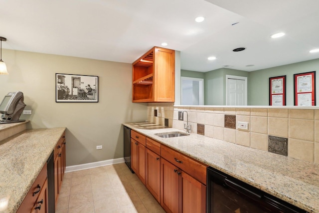 kitchen with a sink, wine cooler, tasteful backsplash, baseboards, and light stone countertops