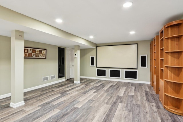 cinema room with wood finished floors, baseboards, and recessed lighting