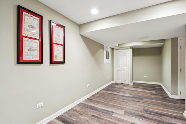 finished below grade area featuring wood finished floors, baseboards, and recessed lighting