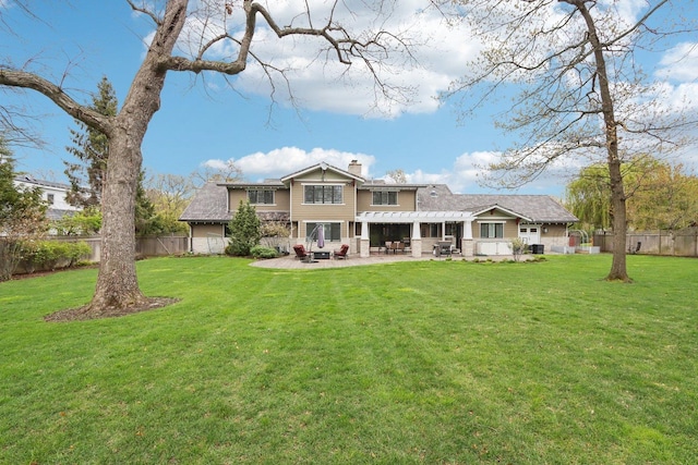 back of house featuring a chimney, a patio area, and a pergola