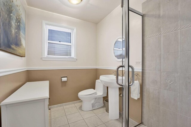full bathroom with tile patterned floors, toilet, and a shower stall