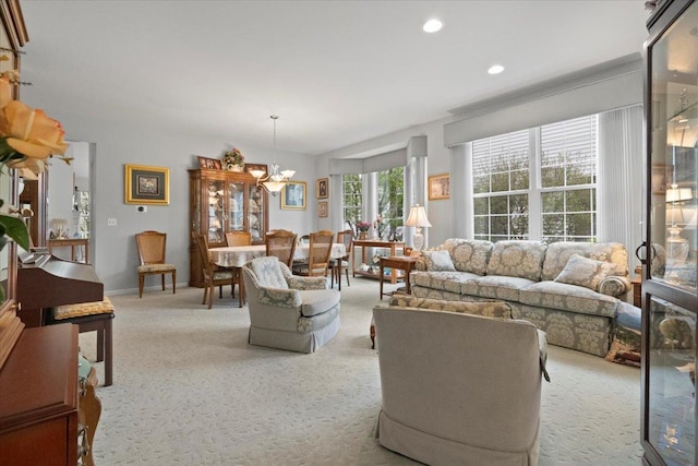 living room featuring carpet flooring, recessed lighting, and an inviting chandelier