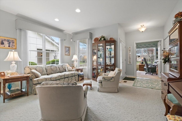 living area featuring recessed lighting and light carpet