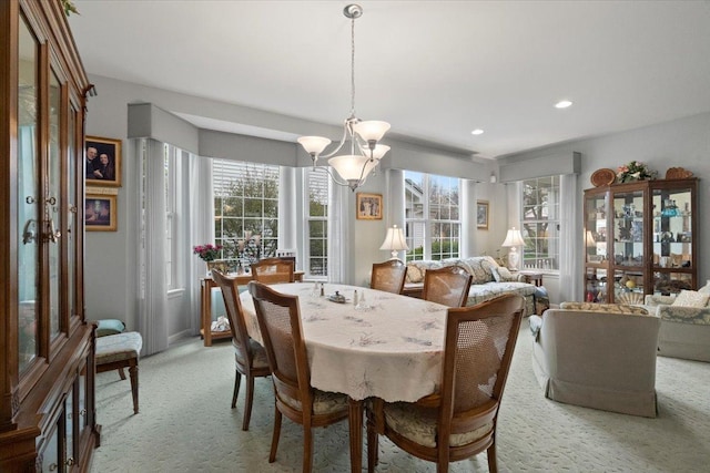 dining area with light colored carpet, recessed lighting, a chandelier, and a wealth of natural light