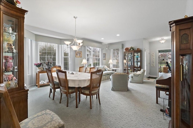 carpeted dining area featuring recessed lighting, baseboards, and a chandelier