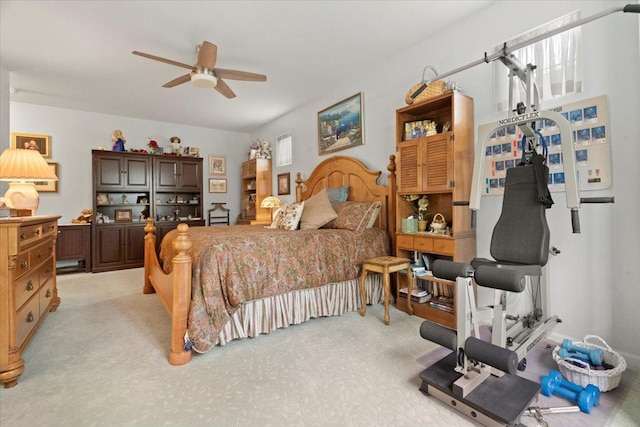 bedroom featuring light colored carpet and a ceiling fan