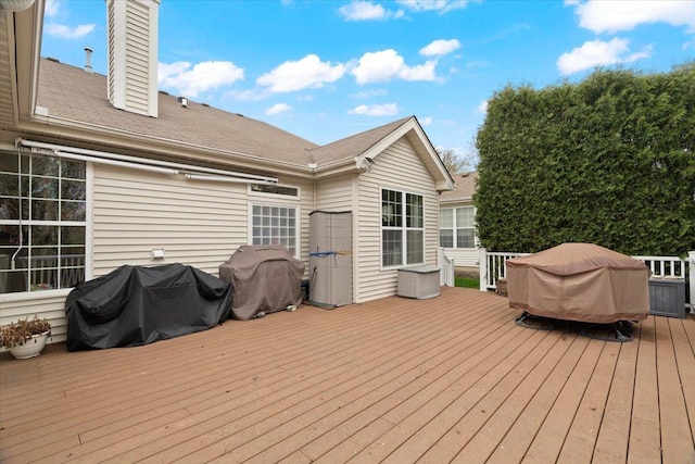 wooden terrace with a grill