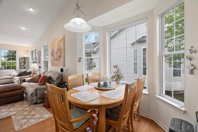 dining room featuring recessed lighting, vaulted ceiling, a healthy amount of sunlight, and light wood-style flooring