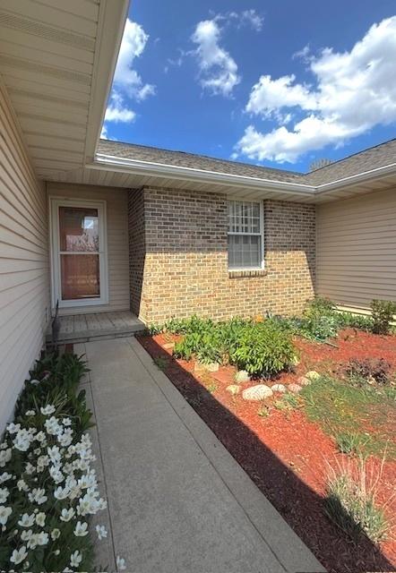 property entrance with brick siding