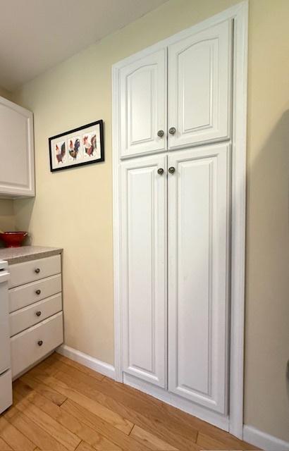 interior space featuring baseboards and wood finished floors