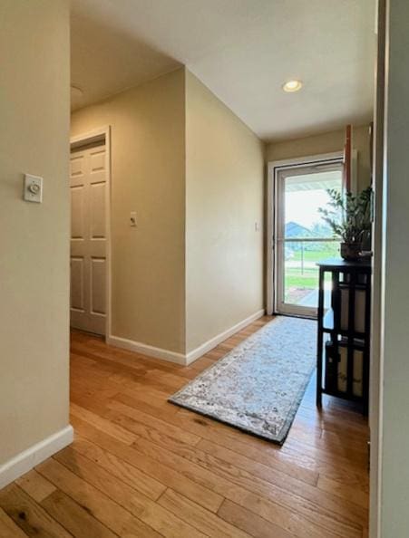 interior space with baseboards and light wood-type flooring
