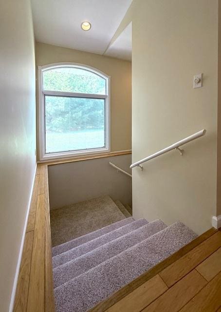 stairs with baseboards and recessed lighting