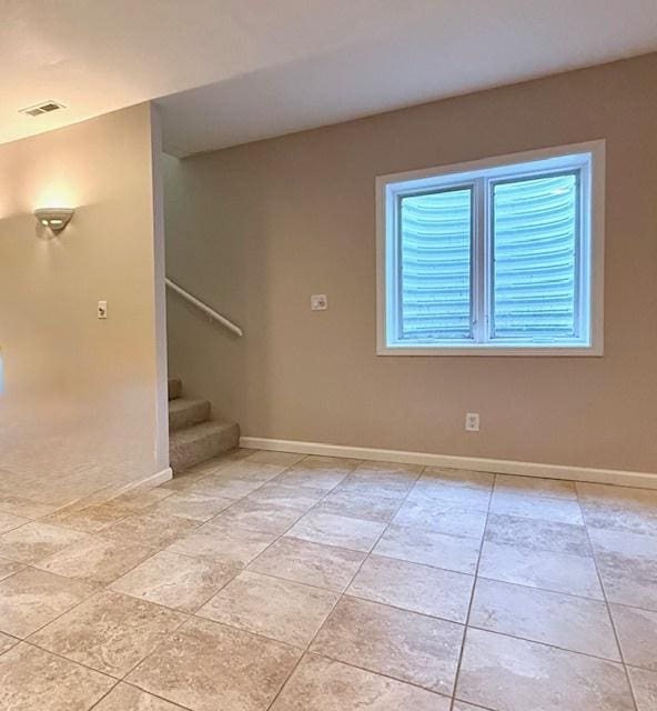 interior space with visible vents, stairs, baseboards, and light tile patterned flooring