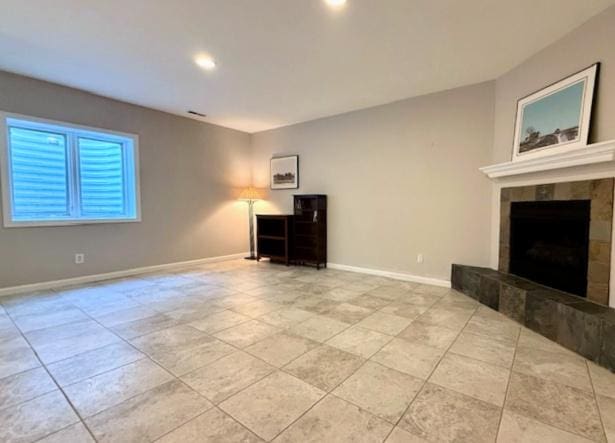 unfurnished living room featuring baseboards, recessed lighting, tile patterned floors, and a fireplace