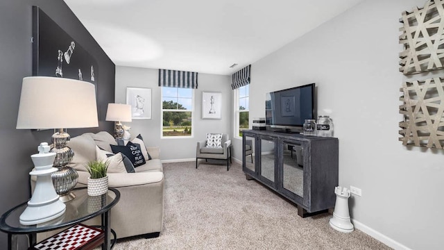 living area with baseboards and carpet flooring