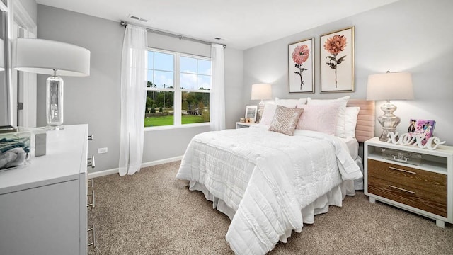 bedroom with light colored carpet, baseboards, and visible vents