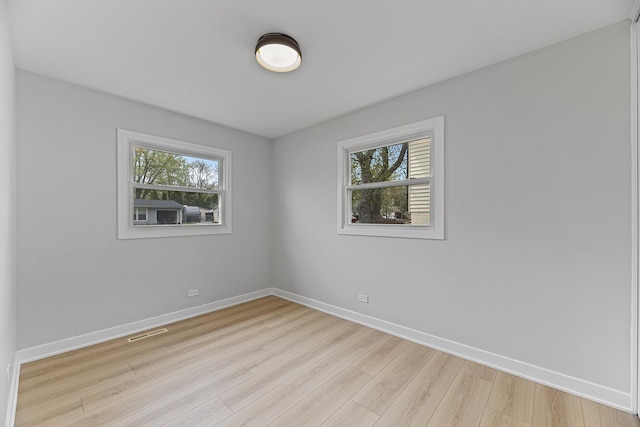 18624 W Pamela Pl, Gurnee, IL 60031 - unfurnished room featuring baseboards, visible vents, plenty of natural light, and light wood-type flooring
