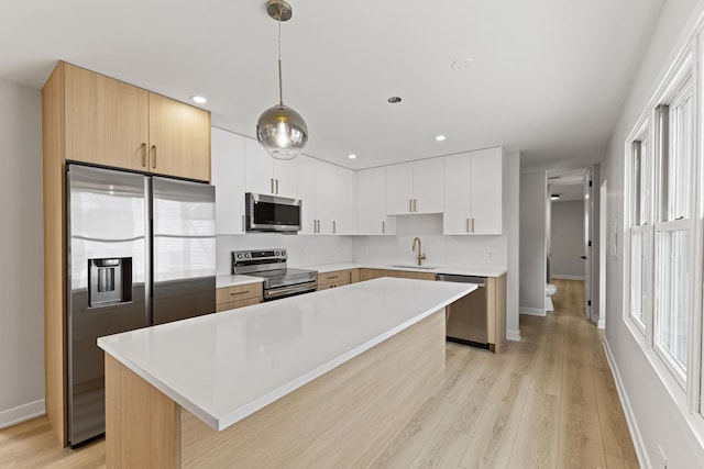 18624 W Pamela Pl, Gurnee, IL 60031 - kitchen with light wood-type flooring, a sink, appliances with stainless steel finishes, and light countertops