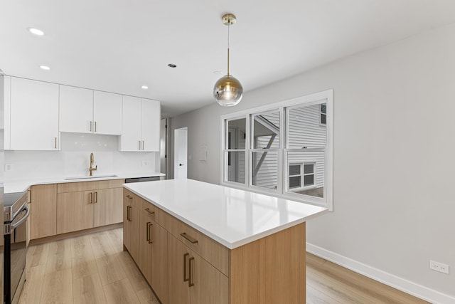 18624 W Pamela Pl, Gurnee, IL 60031 - kitchen with electric range, a kitchen island, recessed lighting, a sink, and light wood finished floors