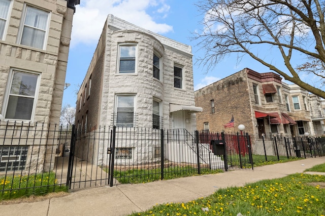 view of front of property with a fenced front yard and a gate