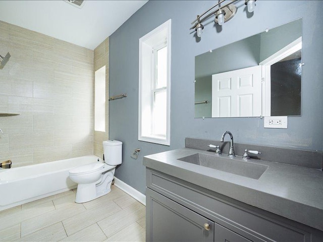 full bathroom featuring toilet, baseboards, shower / tub combination, and vanity