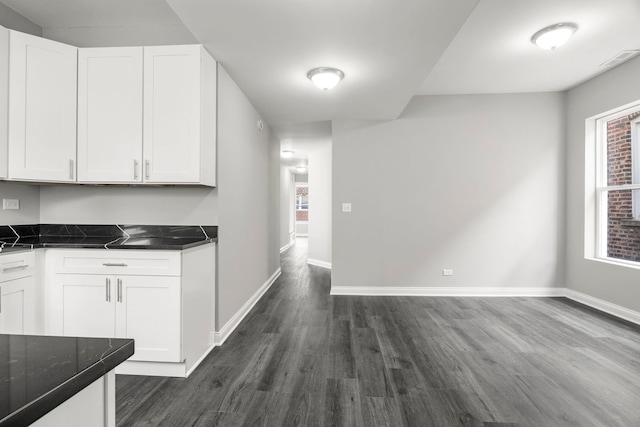kitchen featuring white cabinets, baseboards, dark wood finished floors, and visible vents