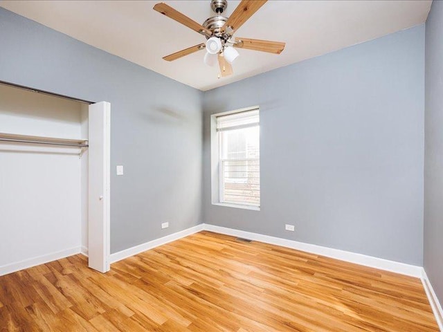 unfurnished bedroom with ceiling fan, visible vents, baseboards, a closet, and light wood-style floors