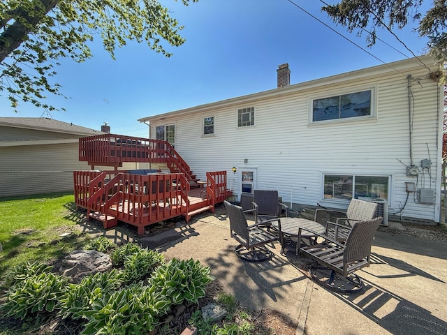 rear view of house featuring a patio, a chimney, a deck, central AC unit, and stairs